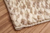 Taupe wool rug shown styled with furniture