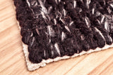 Brown wool rug pile texture close-up detail