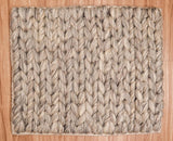 Detail of taupe grey wool rug edge and fringe finishing