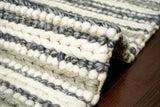 Grey and ivory chunky loop wool rug styled in living room