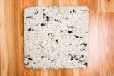 Textured wool rug shown styled with furniture