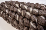 Corner detail of handwoven brown ivory wool rug