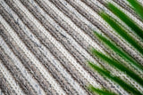 Chunky knit rug texture close-up in natural light