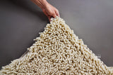Ivory shaggy rug texture close-up in natural light