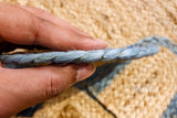 Jute rug corner detail with aqua trim