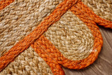 Orange jute rug styled in a living room