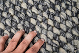 Grey wool rug edge and binding detail