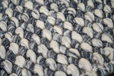 Multi grey wool rug in a bedroom setting