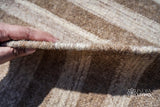 Full view of irregular beige rustic kilim rug on floor