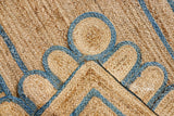 Full view of scalloped jute rug in natural light