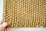 Close-up of tan beige wool rug chunky pile