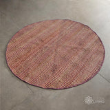 Natural pink round jute rug flat lay showing woven texture