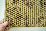 Coffee beige wool rug texture close-up
