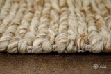 Beige brown wool rug in a Scandinavian bedroom setting
