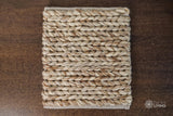 Beige brown braided wool rug flat lay showing chunky texture