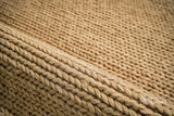 Tan beige wool rug in a bedroom setting