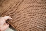 Tan brown wool rug placed under furniture