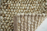 Beige chunky wool rug in a modern nursery