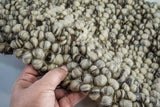 Close-up of ivory and brown wool loop texture