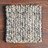 Wool jute pebble rug texture close-up in bedroom