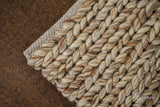 Close-up of beige brown wool rug braided texture