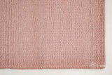 Light pink wool rug in a nursery bedroom setting