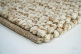 Texture close-up showing hand-knotted wool loops