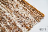Texture close-up of handwoven ivory brown wool