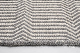 Light grey wool rug in a boho-styled entryway