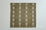 Close-up of olive green wool rug woven texture and pile