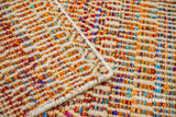 Multi blend orange flatweave rug in a bedroom setting