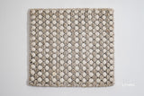 Corner detail of beige cream ribbed wool rug