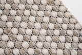 Full view of beige cream ribbed wool rug on floor
