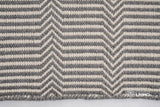 Full view of light grey chevron wool rug on floor