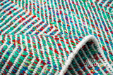 Top-down view of multi blend teal wavy striped rug