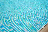 Aqua blue wool rug texture close-up showing handwoven chevron weave