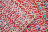Top-down view of multi blend red geometric rug