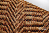 Orange jute rug corner detail showing edge binding