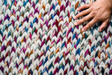 Full view of colourful chunky rug on floor