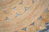 Round jute rug placed in an entryway