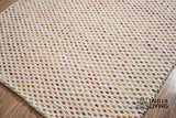Ivory wool rug styled with furniture in room