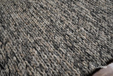 Grey wool rug corner detail showing thick pile