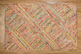 Rainbow rag rug corner detail showing edge binding