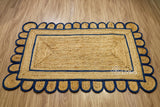 Hand braided navy blue rug shown in an entryway setting