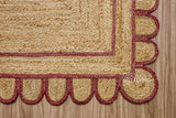 Corner view of burgundy jute runner showing braided weave