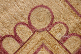 Close-up of scalloped edge detail on burgundy jute runner