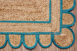 Corner view of teal blue jute runner showing braided weave
