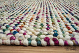 Reversible handwoven chunky wool rug shown at an angle