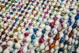 Detail of the rainbow wool loops and woven edge finish