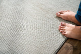 Ivory solid wool rug, full flat view